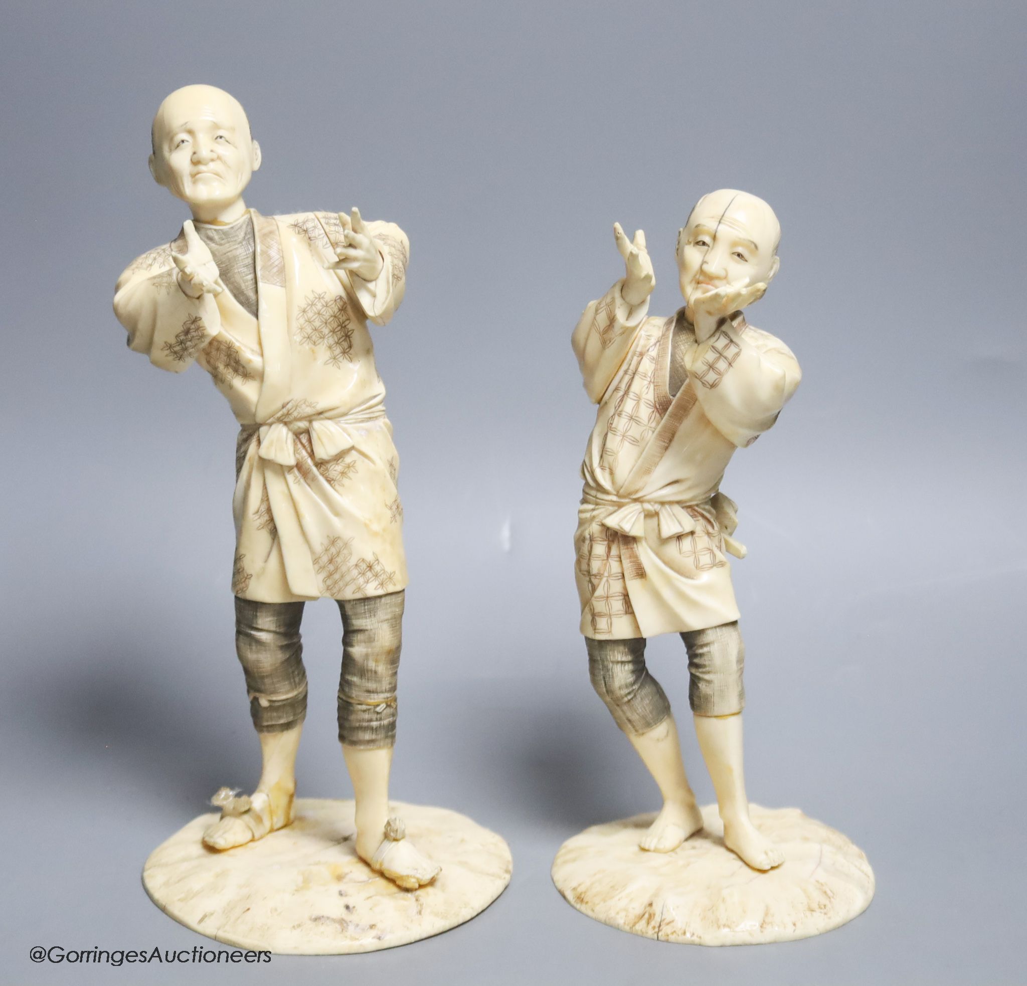 Two Japanese sectional ivory figures of farmers, early 20th century, one signed to base, height 24cm